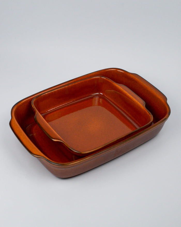 Set of two brown ceramic stoneware baking dishes on a white background