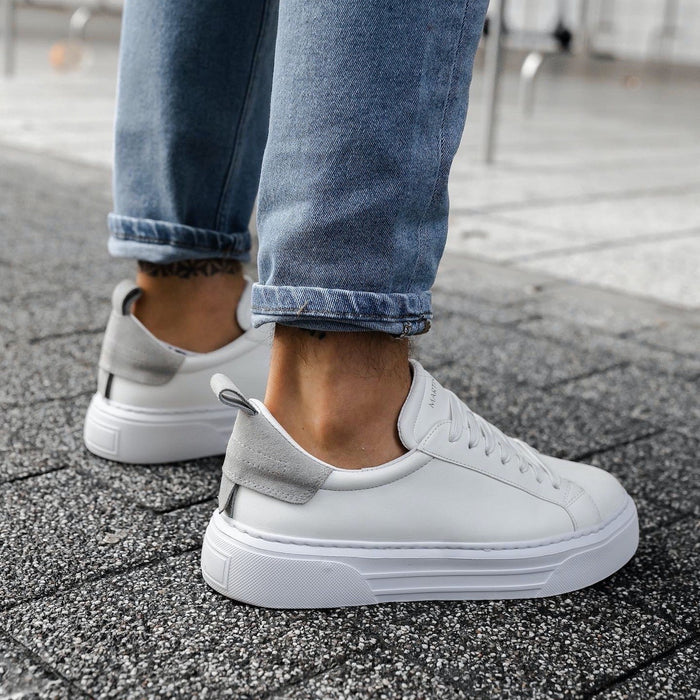 Martin Valen Bobe Suede Belted white sneakers with grey suede heel tab, side-rear on-foot view with rolled jeans highlighting the platform sole