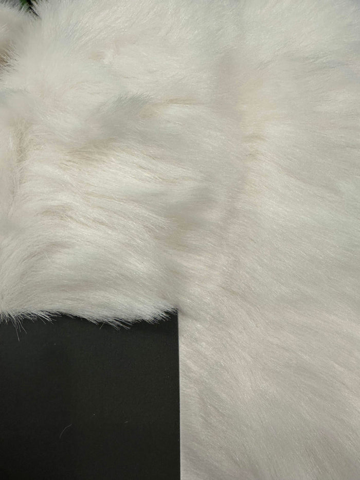 Close-up of white fluffy faux fur fabric texture