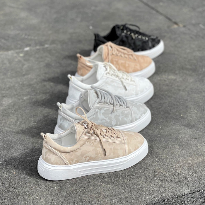 Row of Martin Valen Crowned Shoes low-top sneakers in cream camo and other colors, angled view showing camo pattern and white soles