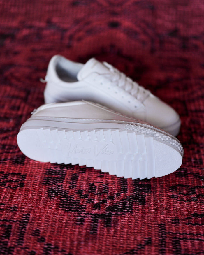 Martin Valen men's low-top white sneakers pictured side-on with the serrated outsole and low profile visible