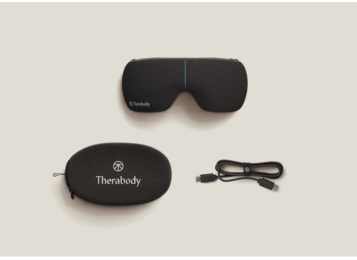 SmartGoggles 2 | Therabody sleep mask in black with carrying case and USB charging cable displayed on a neutral background as wellness and recovery tools.
