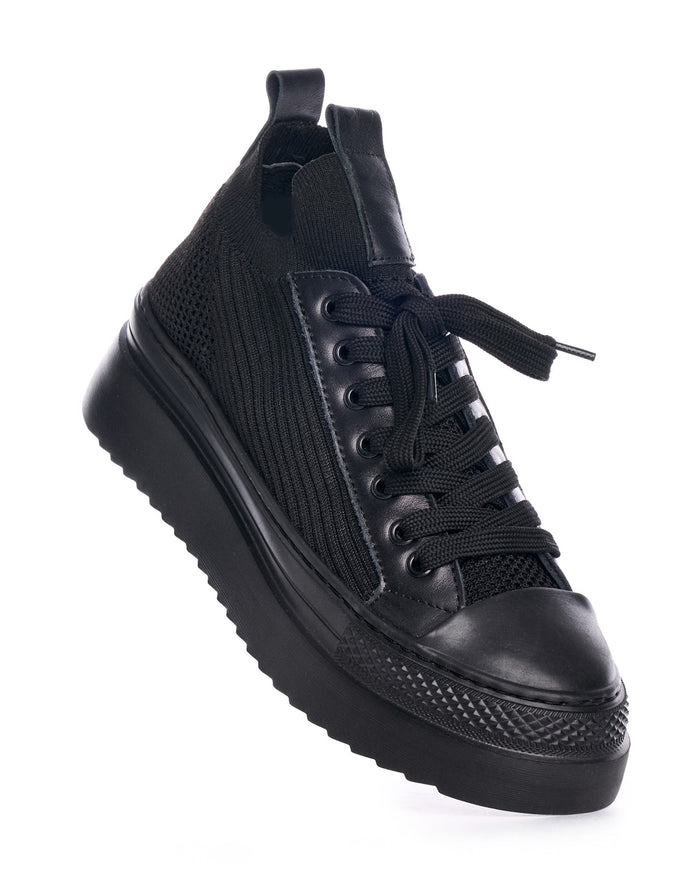 Martin Valen Valento black knitwear sneakers, angled top view showing black laces with metal eyelets, ribbed knit side panels and platform sole