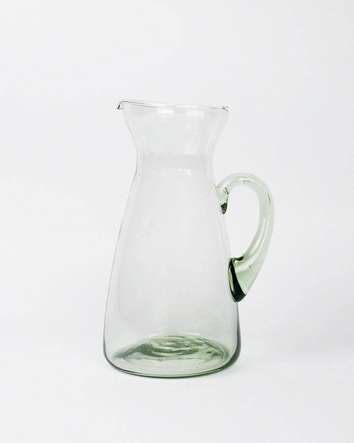 Clear glass pitcher on a white background