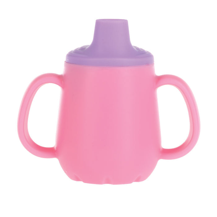The Nuby US 2-Handle First Training Cup in pink features dual handles and a purple Free-Flow spout lid, ideal for young children learning to drink.