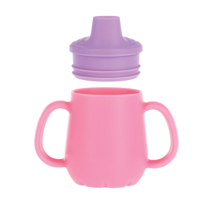 A Nuby US 2-Handle First Training Cup in pink with a purple, spill-proof Free-Flow spout lid is shown above, both set against a white background.