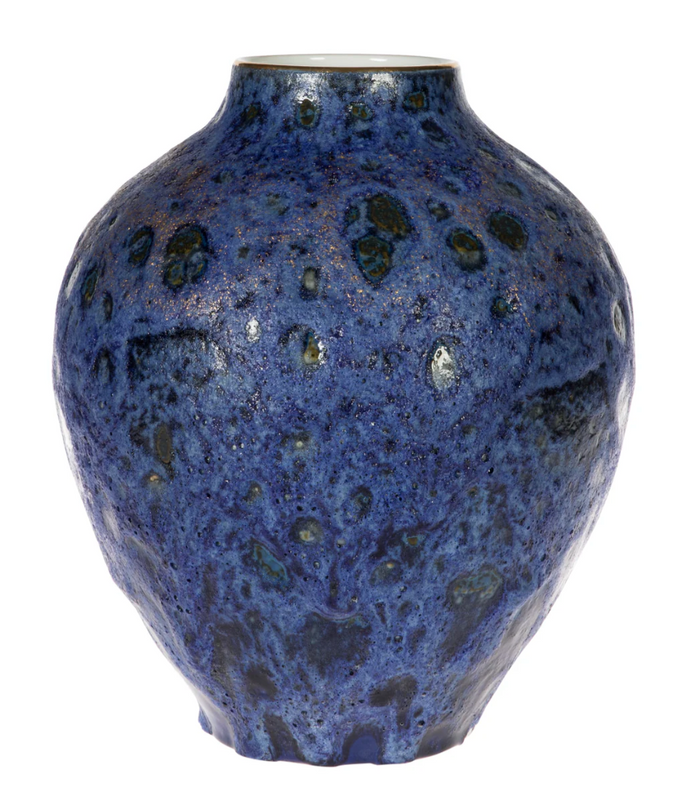 Blue ceramic vase with a textured surface on a white background