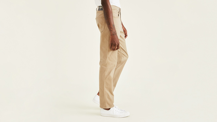 Side view of model wearing New British Khaki Jean Cut Pants, Straight Fit (Big and Tall).