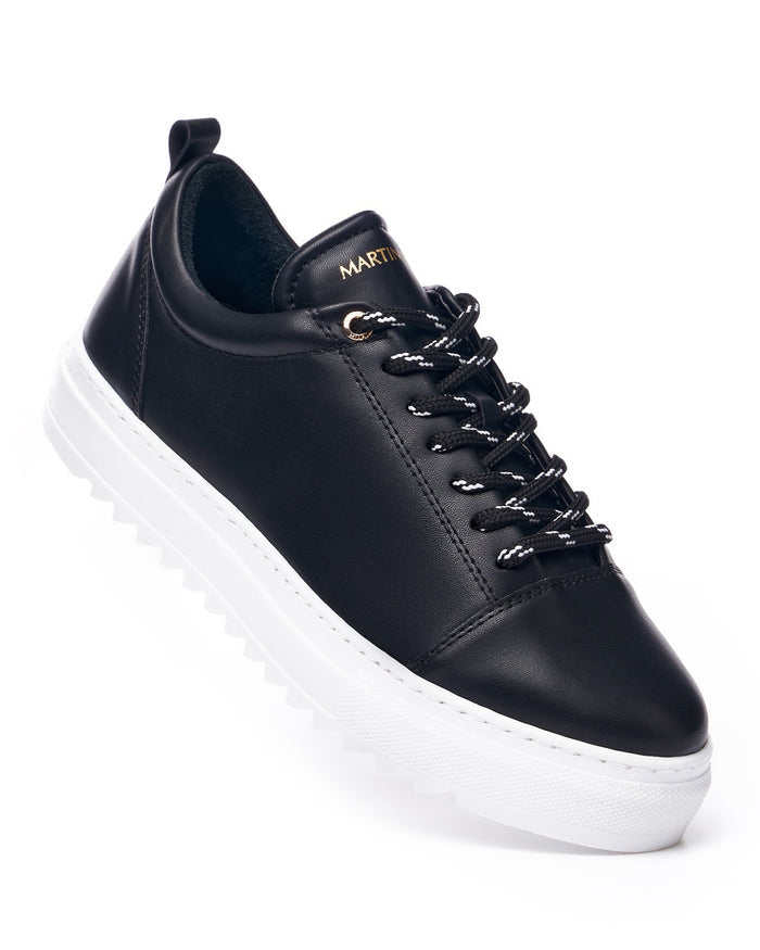 Martin Valen Artestitch low-top black sneaker close-up, white platform sole and black-and-white laces