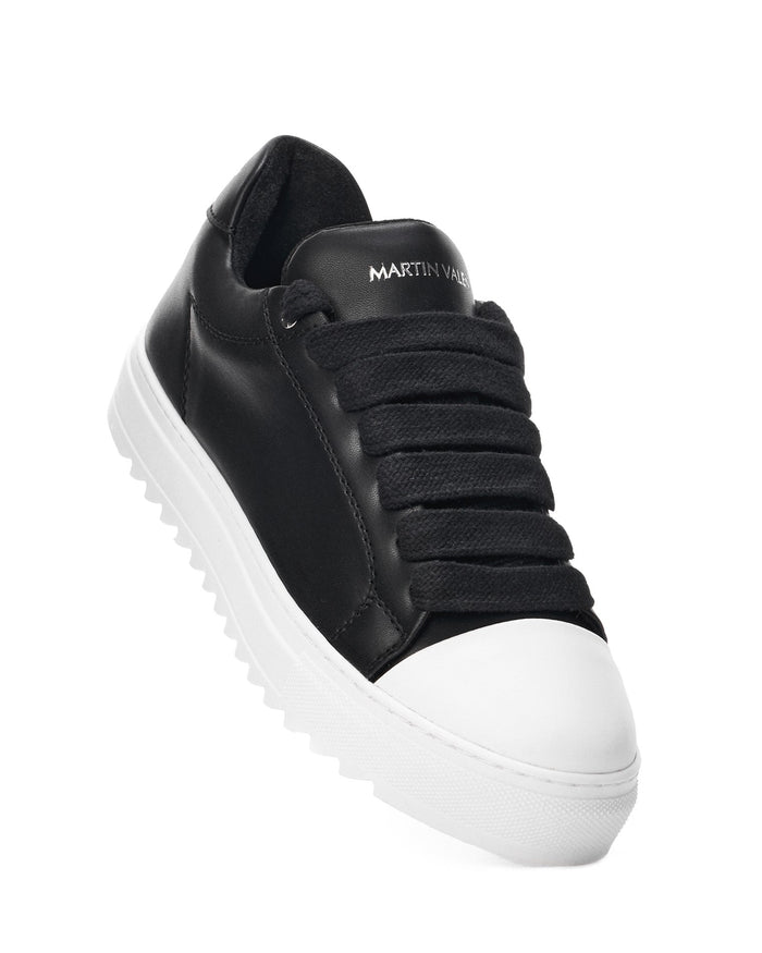 Martin Valen Artisan Cupsole low black-white sneaker angled close-up, showing white toe cap and textured white cupsole