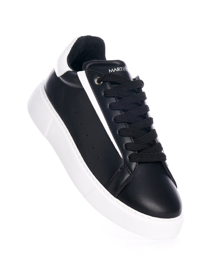 Martin Valen Axino men's black and white sneakers, close side view of the laced upper and padded collar