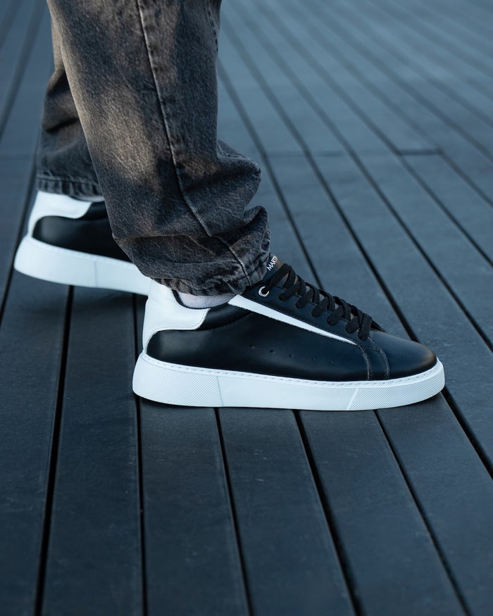Martin Valen Axino men's black sneakers with white details, top-front view showing toe box, laces and white sole edge