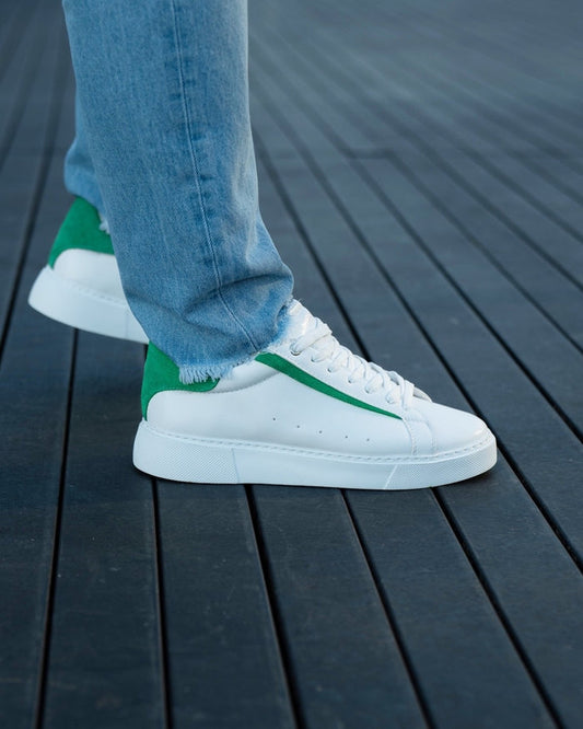 Martin Valen Axino men's white casual sneakers, side view with green heel detail and worn with jeans