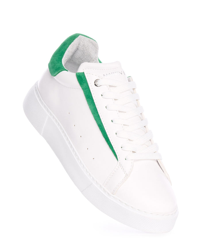 Martin Valen Axino angled view of white sneaker, visible laces and green side trim with raised sole