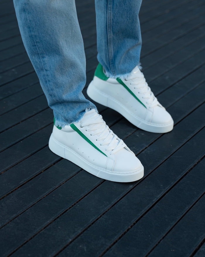 Martin Valen Axino white sneakers worn with jeans, full-foot angled view showing green side stripe and chunky sole