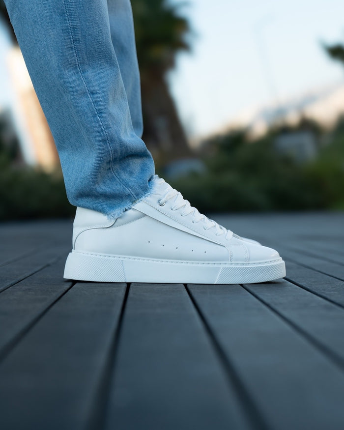 Martin Valen Axino men's casual white sneaker, side lifestyle view worn with light blue jeans showing profile and chunky sole