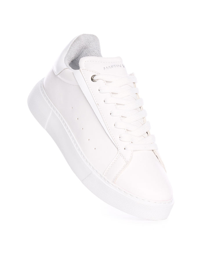 Martin Valen Axino men's casual white sneaker, angled close-up of laces and rounded toe with visible Martin Valen logo on the tongue and perforated side