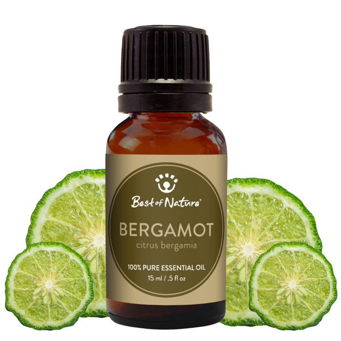 Bottle of Bergamot essential oil with lime slices on a white background
