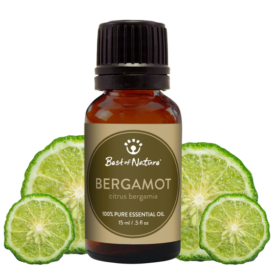 Bottle of Bergamot essential oil with lime slices on a white background