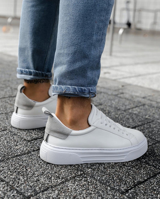 Martin Valen Bobe white and grey sneakers, rear angled shot on foot with rolled jeans showing grey suede heel tab and chunky sole