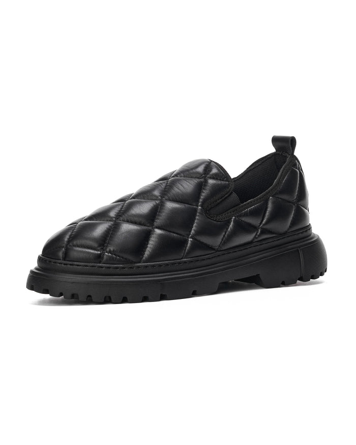 Martin Valen Bold Capitone black shoes profile view showing quilted upper, lugged chunky sole and heel pull tab