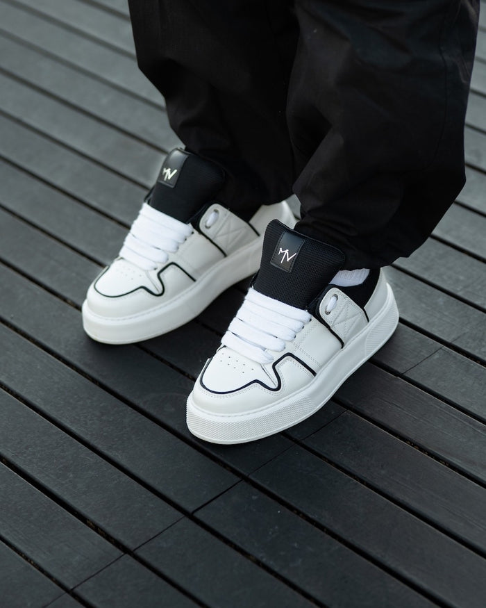 Martin Valen chunky white sneakers seen top-down, black line and black tongue with logo, thick platform sole