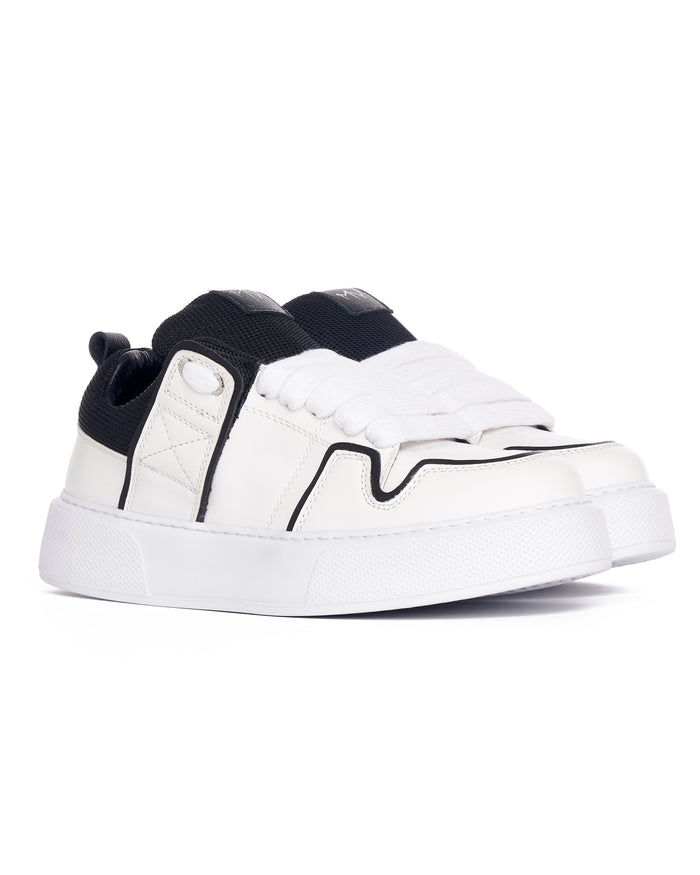 Martin Valen side profile of chunky white sneaker, decorative black line and textured thick sole visible