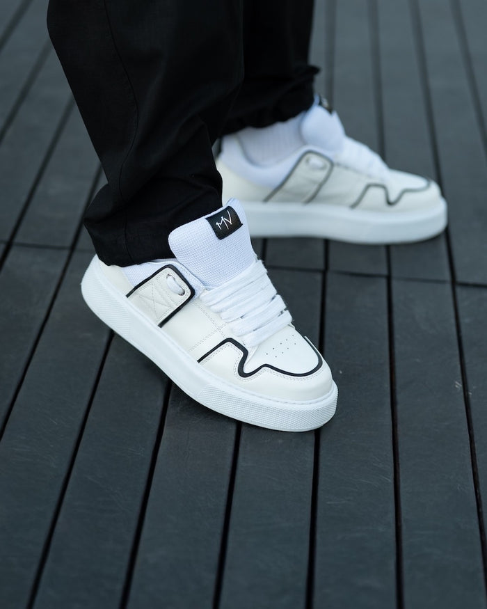Martin Valen chunky white sneakers, side view showing black outline detail and thick white sole