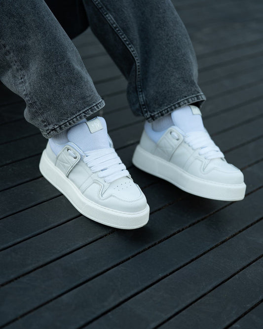 Martin Valen bulky white sneakers, side low-angle view showing platform sole, wide laces and stitched panels