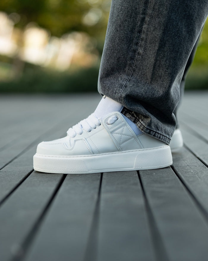 Martin Valen bulky white sneakers, angled side-front view showing perforated toe and thick platform sole
