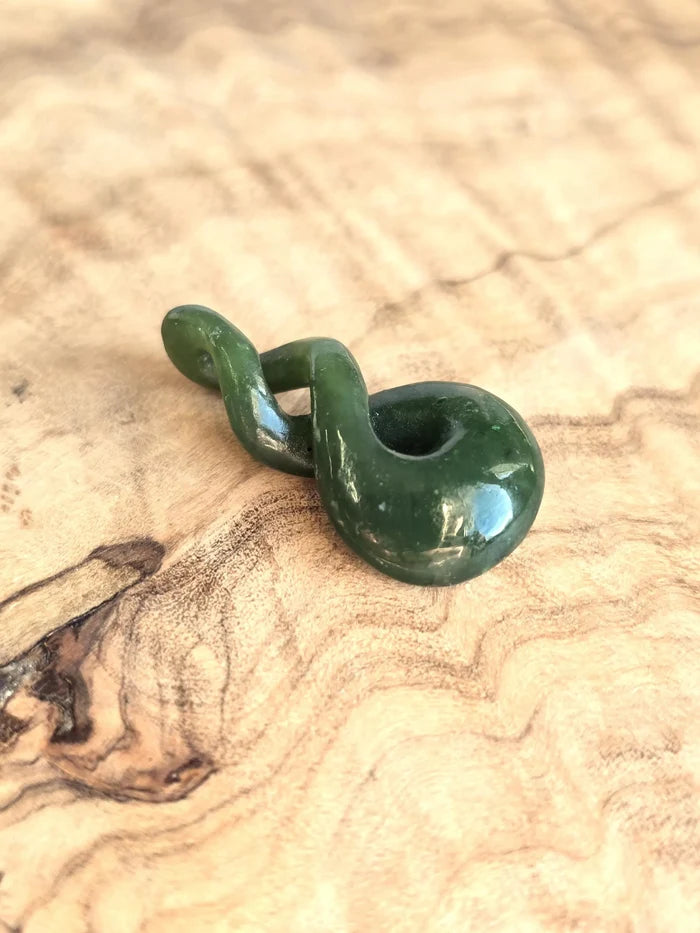 Green jade twist on a wooden base