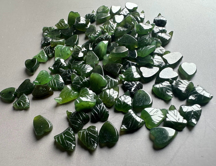 Dark green glossy jade leaf chips with white vein markings and heart shapes