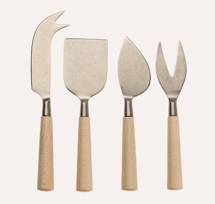 A set of four cheese knives with wooden handles and stainless steel blades, including different shapes for various cheeses.