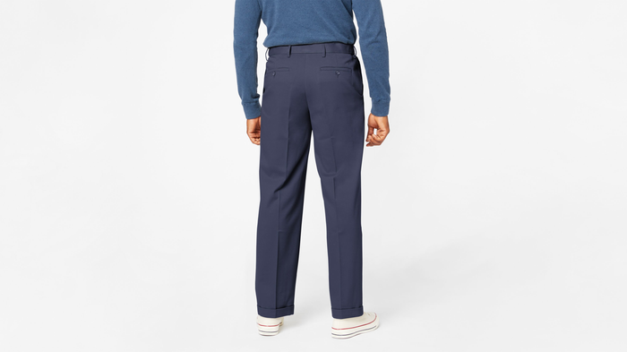 Back view of model wearing Navy Comfort Khakis, Pleated, Relaxed Fit.