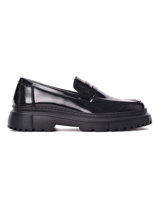 Martin Valen full black loafer with high sole, side profile showing glossy upper, penny strap and lug sole