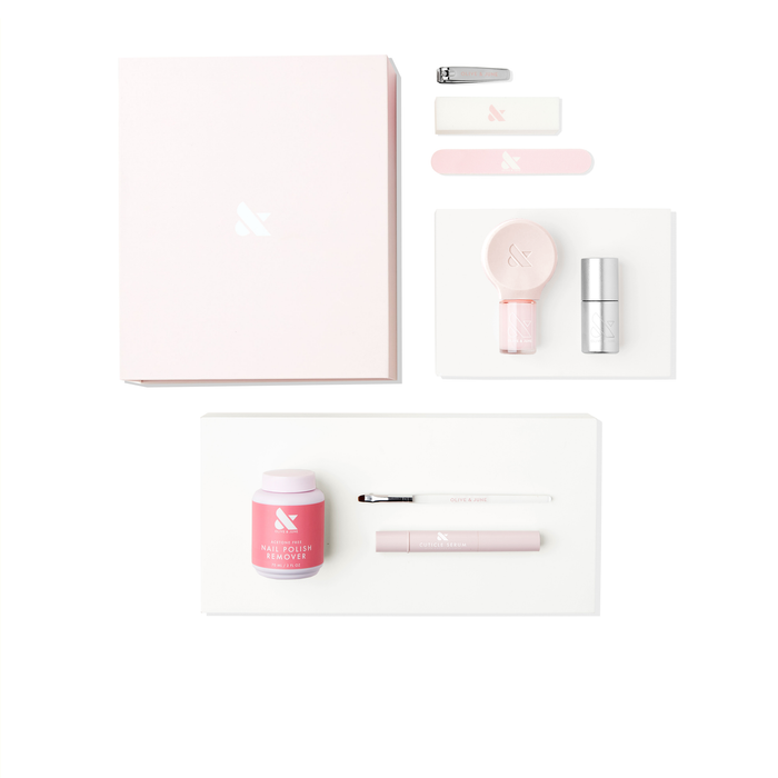 Gift The Mani System kit with nail clipper, buffer, polish remover, brush, and manicure tools on white background