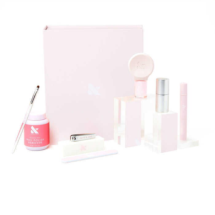Gift The Mani System kit with nail tools and polish remover in soft pink packaging on white background