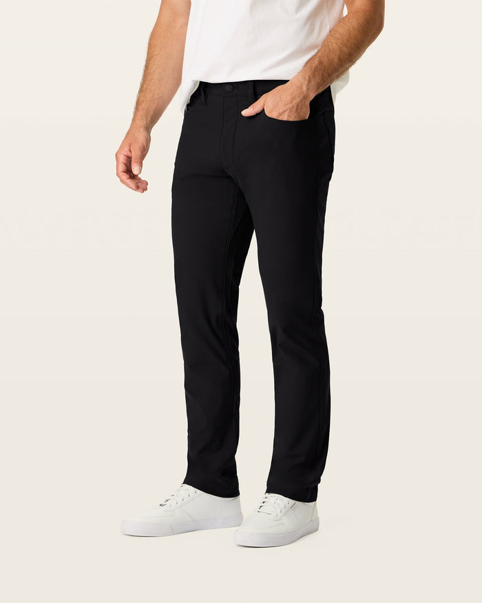 Side view of model wearing Beautiful Black Go Airweave 5-Pocket, Slim Tapered Fit.