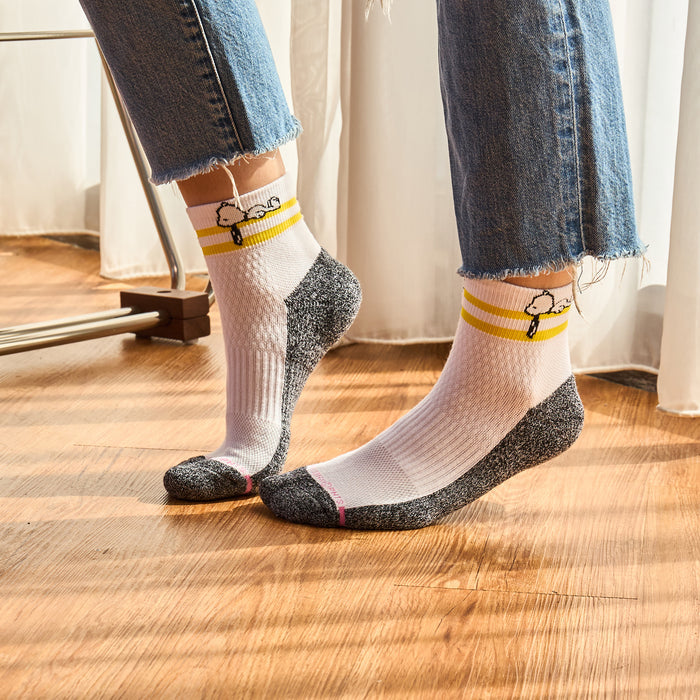 Quarter compression socks with a white body, gray toe, and yellow stripes featuring a cartoon character.