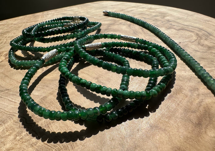 Green Blue beaded bracelets on a wooden surface