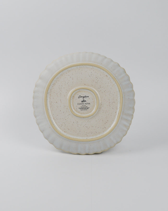 Round ceramic salad plate with textured surface on a white background