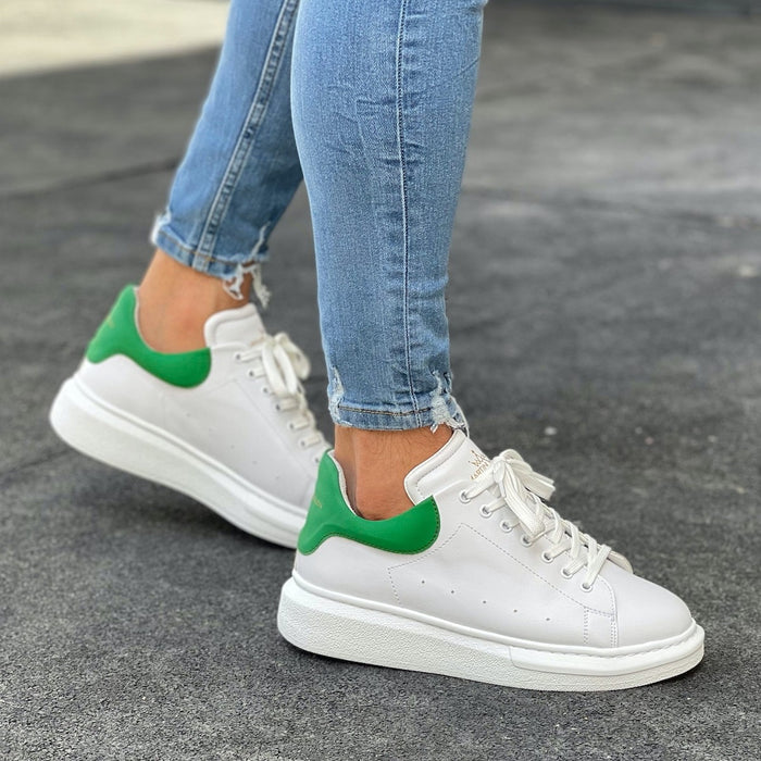 Martin Valen men's chunky white sneakers with green heel, side view on foot wearing jeans, thick platform sole