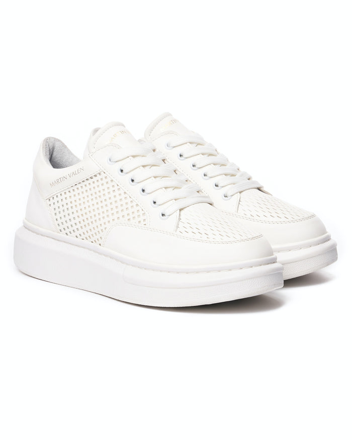 Pair of Martin Valen white sneakers, three-quarter view highlighting laces and perforated side panels