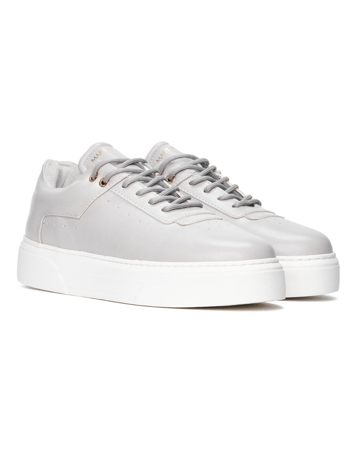 Martin Valen pair of men’s sky gray sneakers, three-quarter front view showing gray laces and gold logo on the tongue
