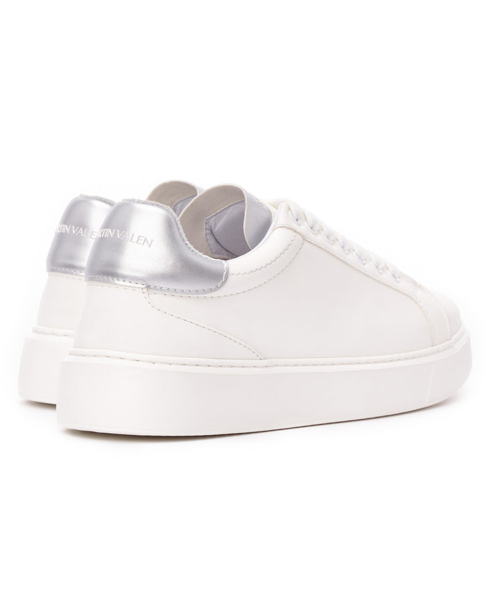 Martin Valen white sneakers rear view showing metallic silver heel tab with visible Martin Valen logo