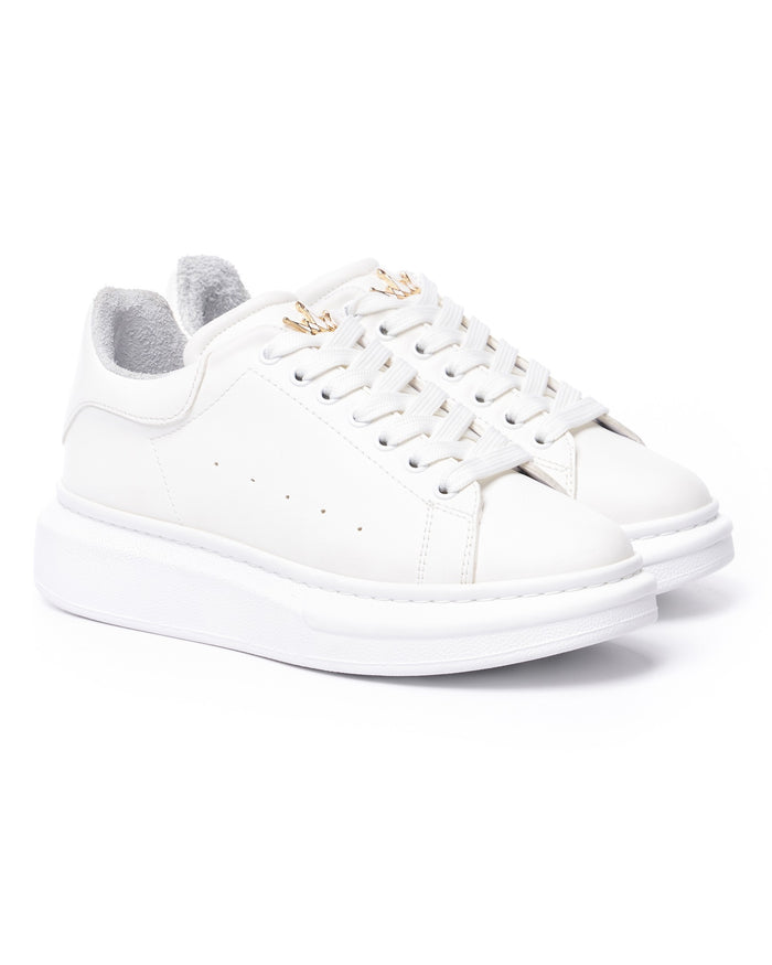 Pair of Martin Valen white Crowned sneakers, close top view showing laces and small gold crown lace charm