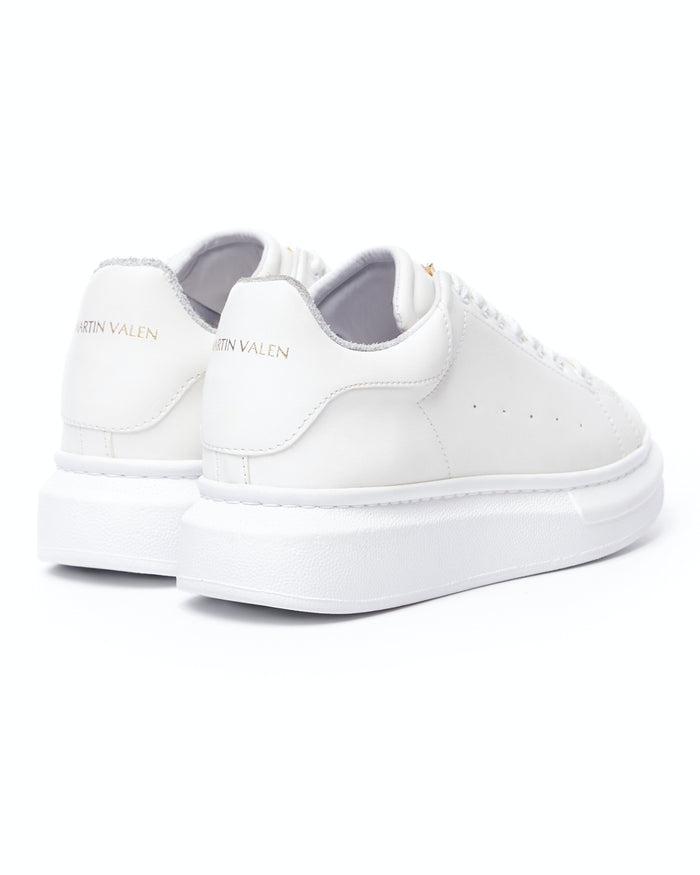Rear view of Martin Valen white Crowned sneakers, close-up showing gold heel logo and padded collar