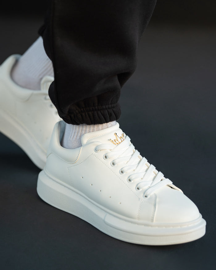 Martin Valen white chunky sneakers three-quarter view, tightened laces and gold crown emblem on the tongue