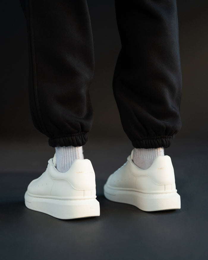 Martin Valen white sneakers front view, close-up of laces and gold crown detail on the tongue