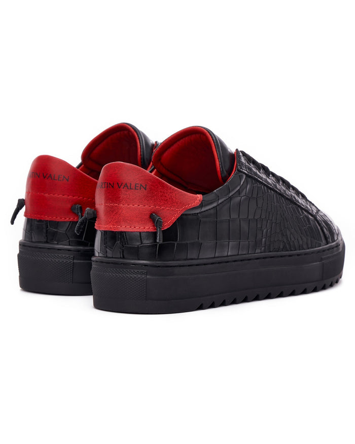 Martin Valen men's low-top black-red sneakers, front three-quarter view showing textured upper, laces and ridged sole